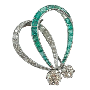 Platinum bow brooch with diamonds and emeralds - Italy 1920s